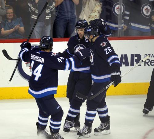Left to right Winnipeg Jets Zach Bogosian, Andrew Ladd and Blake Wheeler celebrate Ladd's empty net goal late in 3rd period action at the MTS Center Thursday night. March 14, 2013 - (Phil Hossack / Winnipeg Free Press)
