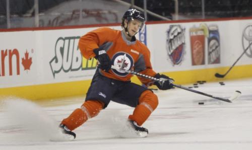 Winnipeg Jets defenceman Toby Enstrom wearing an orange no-contact jersey was skating with a small group of team mates in the MTS Centre Friday morning. This was the second time he was at practice since he was injuried and it is unsure when he will return to the lineup. Ed Tait  story(WAYNE GLOWACKI/WINNIPEG FREE PRESS) Winnipeg Free Press March 15 2013