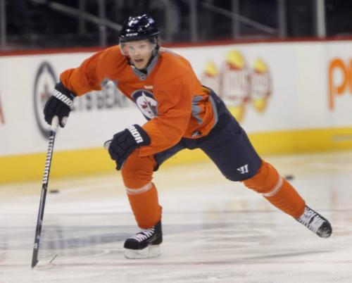 Winnipeg Jets defenceman Toby Enstrom wearing an orange no-contact jersey was skating with a small group of team mates in the MTS Centre Friday morning. This was the second time he has been at practice since he was injured and it is unsure when he will return to the lineup. Ed Tait  story(WAYNE GLOWACKI/WINNIPEG FREE PRESS) Winnipeg Free Press March 15 2013