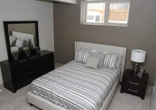 The Health Sciences Centre Foundation Home Lottery Grand Prize is a Tuxedo neighbourhood show home at 137 Aldershot Blvd. valued at $1.4 million. The house features almost 5,000 square feet of living space. Pictured is one of four fully furnished bedrooms, located in the basement, on March 15, 2013. (REPORTER: TODD LEWYS) (JESSICA BURTNICK/WINNIPEG FREE PRESS)