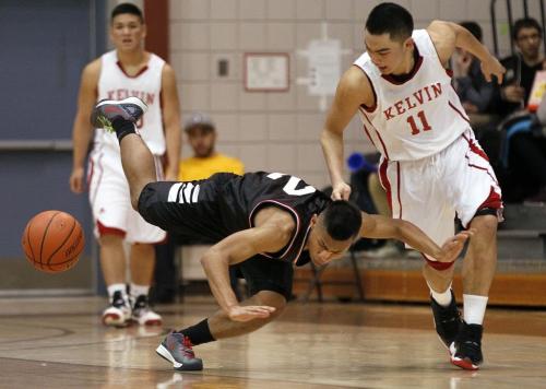 March 15, 2013 - 130315  -  Sisler Spartan Denzel Soliven (2) gets knocked down by Kelvin Clipper Marco Valera (11) in a semi-final of the Provincial Highschool AAAA Basketball Championships at the University of Manitoba Friday, March 15, 2013. John Woods / Winnipeg Free Press