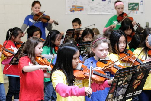 Elwick school grade 2 and 3 students who are part of the Sistema after school program perform for Winnipeg Harvest volunteers Monday afternoon thanking the organization for providing food for their after school program.  130318 March 18, 2013 Mike Deal / Winnipeg Free Press