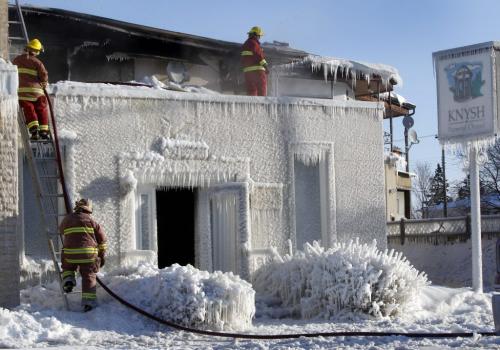 Firefighters check for hot spots after an overnight fire destroyed the Knysh Funeral Chapel on Park Ave. in Beausejour Mb. Tueday morning.  Ashley Prest story (WAYNE GLOWACKI/WINNIPEG FREE PRESS) Winnipeg Free Press March 19 2013