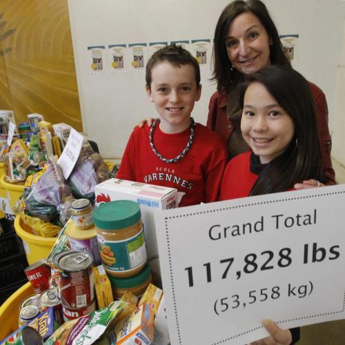 At left, Cameron Tramley and Kateesha Wai students from École Varennes with Chris Albi with Winnipeg Harvest hold up the results from the total raised during the 14th Annual Operation Donation School Food Drive. École Varennes  was one of the 69 Manitoba schools involved that collected a total of 11,871 kg. of food, the Manitoba Public Insurance offices brought in 5,943 kg. Peak of the Market and Canada Safeway matched those donations for a total 53,558 kg. of food.  Ashley Prest story (WAYNE GLOWACKI/WINNIPEG FREE PRESS) Winnipeg Free Press March 19 2013