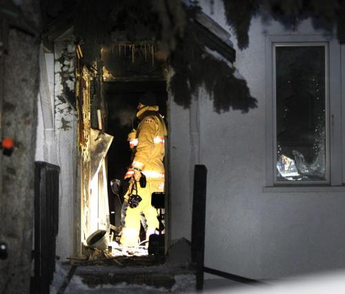 A member with the Winnipeg Fire Dept. investigates the area at the back of a house in the 400 block of Magnus Ave. Wednesday morning that was extensively damaged from a overnight fire.(WAYNE GLOWACKI/WINNIPEG FREE PRESS) Winnipeg Free Press March 20 2013
