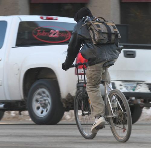 Brave Rider- A cyclist braves the Portage and Main St intersection in downtown Winnipeg Wednesday morning- standup photo- March 20, 2013   (JOE BRYKSA / WINNIPEG FREE PRESS)