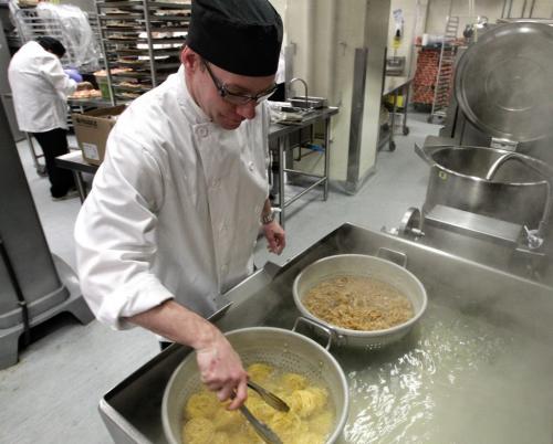 Chef Clayton Koll prepares pasta for Winnipeg Jets players' lunch buffet Tuesday in the kitchen at the MTS Centre.    130319 March 19, 2013 Mike Deal / Winnipeg Free Press