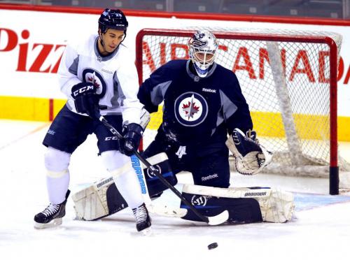 Patrice Cormier tries to deflect a shot past goalie Edward Pasquale during practice at the MTS Centre in Winnipeg Wednesday afternoon.. March 20, 2013  BORIS MINKEVICH / WINNIPEG FREE PRESS