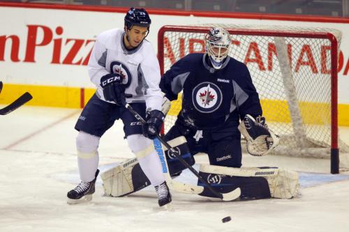 Patrice Cormier tries to deflect a shot past goalie Edward Pasquale during practice at the MTS Centre in Winnipeg Wednesday afternoon. March 20, 2013  BORIS MINKEVICH / WINNIPEG FREE PRESS