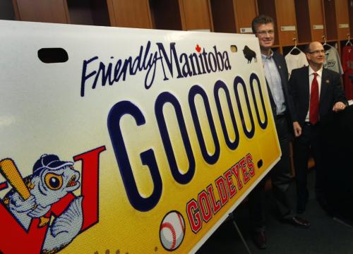 At right, Andrew Collier, GM of the Winnipeg Goldeyes and Andrew Swan, Justice Minister unveiled the design of the new Winnipeg Goldeyes' specialty licence plate at Shaw Park Friday. The new plates will cost $70, with $30 of the purchase going to the Winnipeg Goldeyes' Field of Dreams Foundation.   Melissa Martin story (WAYNE GLOWACKI/WINNIPEG FREE PRESS) Winnipeg Free Press March 22 2013