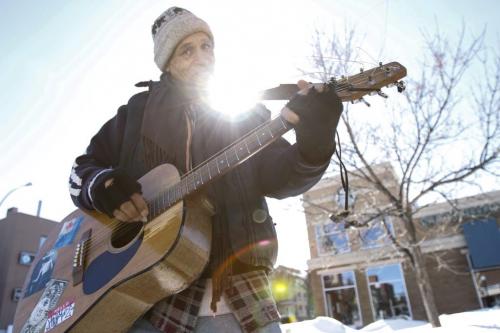 It appears that Eric "The Great" Pyle couldn't have chosen a nicer day to busk on the corner of River Ave. and Osborne St. on Friday, March 22, 2013, but he says he's a regular on the popular street corner and uses his guitar to spread love to others. (JESSICA BURTNICK/WINNIPEG FREE PRESS)