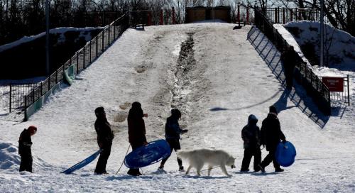 As the spring day fades away group of sledders heads home after enjoying wht might be one of the last days on the toboggan slide at Assinaboine Park. Temps tomorrow will be ???warm again and the sled run is already sufferning theeffects of longer warmer days. March 25, 2013 - (Phil Hossack / Winnipeg Free Press)