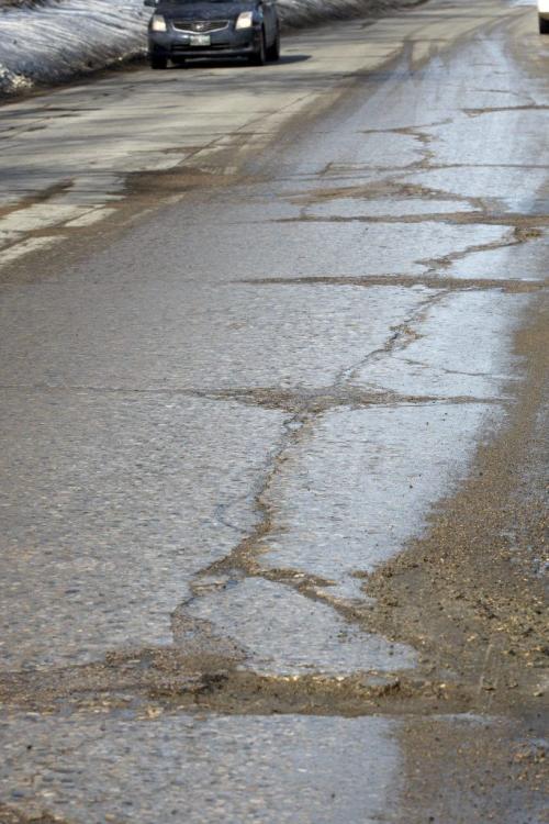 In pic potholes around the city - old scarred up road on Selkirk ST at Railway Ave - City crews ramp up pot hole repair efforts , 6 city Road Patchers and 5 hand-asphalting crews are currently working  are out on Priority One and Priority Two streets , call 311 or email at 311@winnipeg.ca. To report potholes Äì  KEN GIGLIOTTI / Mar. 26 2013 / WINNIPEG FREE PRESS