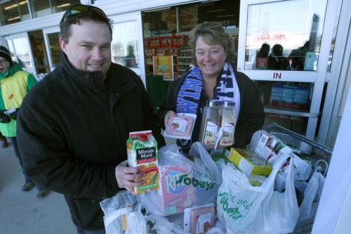 Joel Parent - VP business development for ICUC Moderation Services Inc., and Siloam Missions Judy Richichi collect groceries for Mission at Sobeys on St Annes Road -See pre-easter dinner  story- March 26, 2013   (JOE BRYKSA / WINNIPEG FREE PRESS)