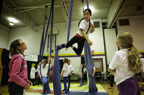 Jana Olayan, 10, practices manoeuvres at the aerial dance station during the Circus and Magic Partnership (CAMP) being held at Gordon Bell High School. More than 250 at-risk kids are taking part in the program during spring break, a program that gives them opportunities to learn to juggle, walk on a tightrope and stilts, swing on a trapeze, aerial dance, magic tricks and more. 130327 March 27, 2013 Mike Deal / Winnipeg Free Press