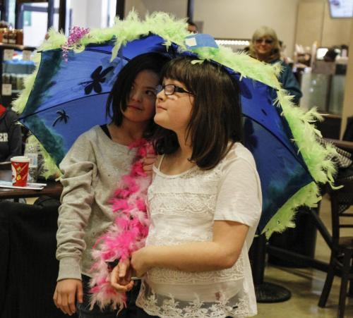 Sisters (right to left) Maggie and Aura Wilkinson, aged 9 and 12 respectively, eagerly await the judging of their umbrella creation. A slough of local media and personality types including CFL quarterback Buck Pearce, Virgin Radio's Adam West and the Winnipeg Free Press' very own columnist Doug Spiers took part in an umbrella decorating contest to kick off a joint fundraising campaign between Easter Seals, Special Olympics and Canada Safeway on Wednesday, March 27, 2013. The event was held at the Safeway located on River Ave. at Osborne St. (REPORTER: DOUG SPIERS) (JESSICA BURTNICK/WINNIPEG FREE PRESS)