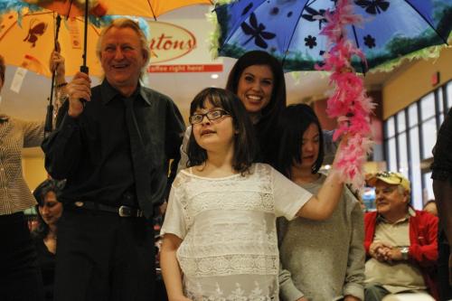Judge and competition winner Maggie Wilkinson (front), age 9, poses with local celebrities during a photo op at Safeway on Wednesday afternoon. A slough of local media and personality types including CFL quarterback Buck Pearce, Virgin Radio's Adam West and the Winnipeg Free Press' very own columnist Doug Spiers took part in an umbrella decorating contest to kick off a joint fundraising campaign between Easter Seals, Special Olympics and Canada Safeway on Wednesday, March 27, 2013. The event was held at the Safeway located on River Ave. at Osborne St. (REPORTER: DOUG SPIERS) (JESSICA BURTNICK/WINNIPEG FREE PRESS)