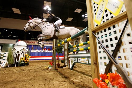 Brandon Sun 27032013 Taylor Parks of Alexander jumps her horse over an obstacle during the popular Prairie Dodge Dog / Horse Relay at the Royal Manitoba Winter Fair on Wednesday evening. (Tim Smith/Brandon Sun)