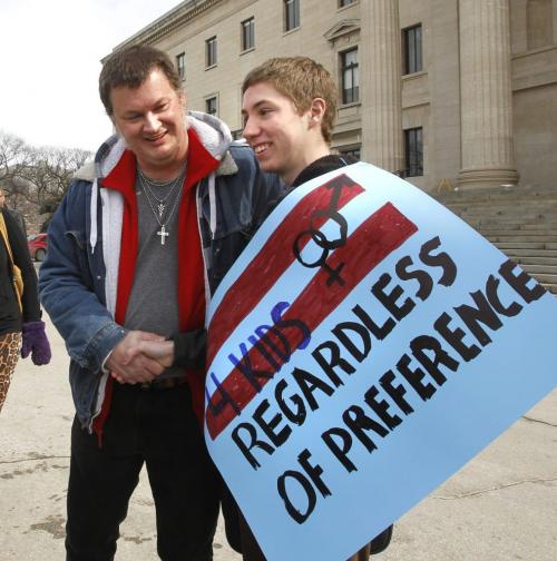 At left, organizer Phil Dupuis meets Ryan Zacharias one of the  about 100 people that attended a rally in front of the Manitoba Legislative building Thursday afternoon in support of the Manitoba government's Bill 18.  (WAYNE GLOWACKI/WINNIPEG FREE PRESS) Winnipeg Free Press March 28 2013