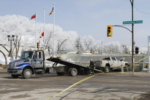 A tow truck arrived at the intersection of Chancellor Matheson and University Drive around 1 p.m. on Friday, March 29, 2013 to clear away a truck involved in a serious motor vehicle collision in the early morning hours (the Winnipeg Police Service responded to the crash around at 3:20 a.m.). There was major damage to the stairwell at the site of the crash. (JESSICA BURTNICK/WINNIPEG FREE PRESS)