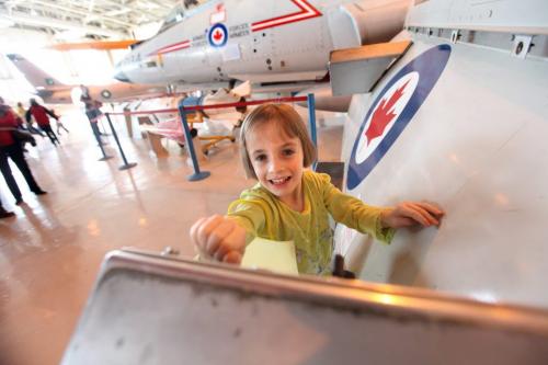 The Western Canadian Aviation Museum was host to hundreds of little egg hunters of all ages Saturday morning for their  annual Easter Egg Hunt. Four year old Sophia Topnick enjoys pushing the buttons on a display after hunting for eggs. Standup Photo Photography Ruth Bonneville  Ruth Bonneville /  Winnipeg Free Press)