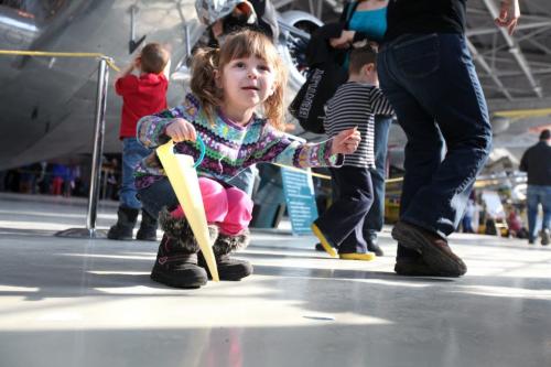 The Western Canadian Aviation Museum was host to hundreds of little egg hunters of all ages Saturday morning for their  annual Easter Egg Hunt.  Three year old Alana Waruk picks up paper eggs that she can redeem for real chocolate eggs after her hunt. Standup Photo Photography Ruth Bonneville  Ruth Bonneville /  Winnipeg Free Press)