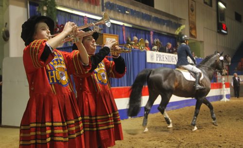 Brandon Sun The Royal Manitoba Winter Fair trumpeters single the entrance of Karen Cudmore into the show ring on Saturday evening during the MTS Grand Prix Cup. (Bruce Bumstead/Brandon Sun)