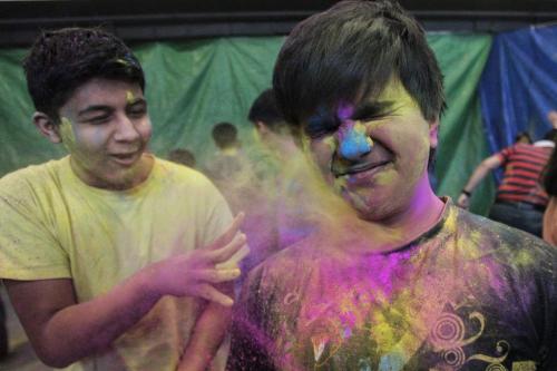 (L-r) Pujan Trivedi, 15, and Dhaval Vora, 14, observe Holi, a religious spring festival celebrated by Hindus as a festival of colours at the Dr. Raj Pandey Hindu Centre Sunday afternoon.  130331 March 31, 2013 Mike Deal / Winnipeg Free Press