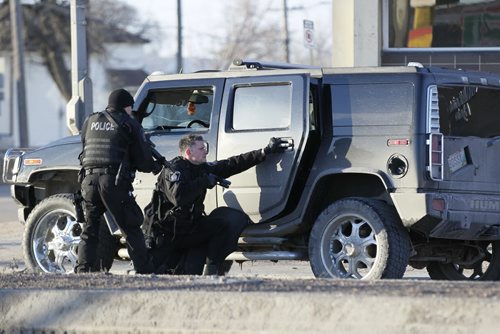 March 31, 2013 - 130303  -  Police tactical unit take down the occupants of a vehicle on Notre Dame at Erin Sunday, March 31, 2013. John Woods / Winnipeg Free Press