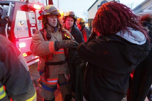 March 31, 2013 - 130331  -  A Winnipeg firefighter hands over a kitten to Morgan Paul after rescuing it in from a tree on the 500 block of Pritchard Sunday, March 31, 2013. The cat had been stuck in the tree for four days. John Woods / Winnipeg Free Press
