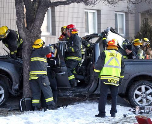 Winnipeg Fire Fighters had to remove the roof of a pickup truck to extricate the injured driver Monday morning. The vehicle was heading down Main St. and crashed into a tree on the front yard of the Kildonan Villa across the street from the Kildonan Park Golf Course. The driver was transported to hospital.   (WAYNE GLOWACKI/WINNIPEG FREE PRESS) Winnipeg Free Press April 1 2013