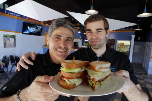 Gus & Tony's at the park - Club Sandwich story by Sanderson. Tony Vailas and his Son Gus pose for a photo with the club sandwich they serve. April 1, 2013  BORIS MINKEVICH / WINNIPEG FREE PRESS