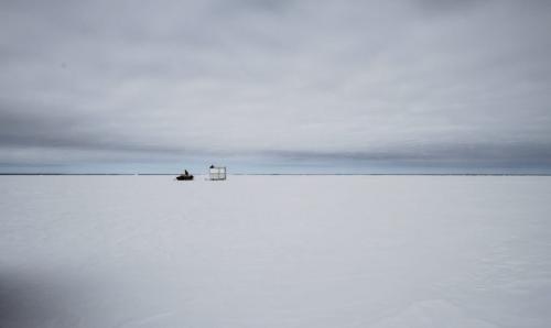 Fairford, Man. ice fisherman Frank Kenyon pulls a wooden shack on skis behind his snow machine onto Lake Manitoba. The shack contains a stove so the fishermen can warm up on cold days. Tuesday, March 26, 2013. (REPORTER: BARTLEY KIVES) (JESSICA BURTNICK/WINNIPEG FREE PRESS)