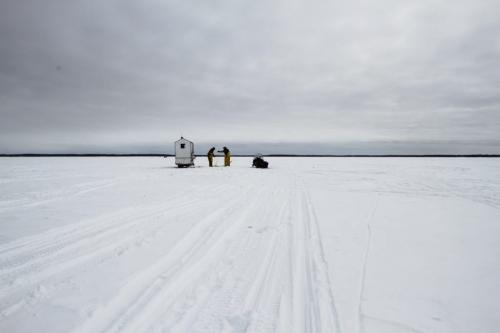 Fairford, Man. ice fishermen Randy Strawa and Frank Kenyon draw in one of around 45 nets they've set on Lake Manitoba. Tuesday, March 26, 2013. (REPORTER: BARTLEY KIVES) (JESSICA BURTNICK/WINNIPEG FREE PRESS)
