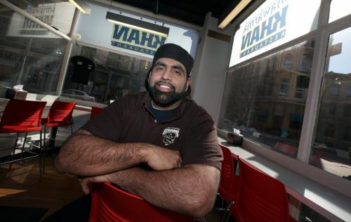 Obby Khan poses in his Market Square area restraunt Tuesday. THe Bomber is now joining the coaching staff at U of M. See story. April 2, 2013 - (Phil Hossack / Winnipeg Free Press)