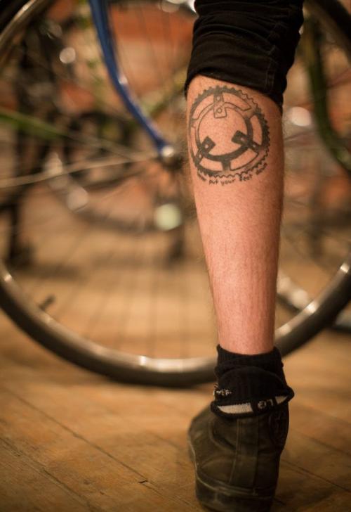 Co-op member Andrew Dalton tattooed his left leg. "Never put your feet down." Natural Cycle in the Exchange District is a co-op owned repair shop and store. Custom bicycle builds, using new and used parts, is common. 130403 - Wednesday, April 03, 2013 - (Melissa Tait / Winnipeg Free Press)