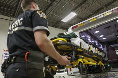 Paramedic JP Berard demonstrates the new power stretcher system to be trialled in city ambulances as announced today by the Province of Manitoba and the City of Winnipeg. The new stretchers will eliminate the need for patients to be manually lifted in and out of ambulances, significantly reducing the risk of injury to Winnipeg Fire Paramedic Service members. Friday, April 5, 2013. (JESSICA BURTNICK/WINNIPEG FREE PRESS)