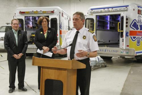Today the Province of Manitoba and the City of Winnipeg announced a power stretcher system trial in city ambulances at Winnipeg Fire Paramedic Station 40 on McPhillips St. at Pacific Ave. (Right) Winnipeg Fire Paramedic Service Chief Douglas Reid spoke about the significance of the new stretchers, especially given the the rising rate of obesity across North America. (Left to right) Scott Fielding, Chair of the Standing Policy Committee on Protection and Community Services, and Health Minister Theresa Oswald were also present. The new power stretchers will eliminate the need for patients to be manually lifted in and out of ambulances, significantly reducing the risk of injury to Winnipeg Fire Paramedic Service members. Friday, April 5, 2013. (JESSICA BURTNICK/WINNIPEG FREE PRESS)