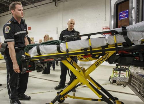 (Left to right) Paramedics JP Berard and Stephen Bel demonstrate the new power stretcher system to be trialled in city ambulances as announced today by the Province of Manitoba and the City of Winnipeg. The new stretchers will eliminate the need for patients to be manually lifted in and out of ambulances, significantly reducing the risk of injury to Winnipeg Fire Paramedic Service members. Friday, April 5, 2013. (JESSICA BURTNICK/WINNIPEG FREE PRESS)