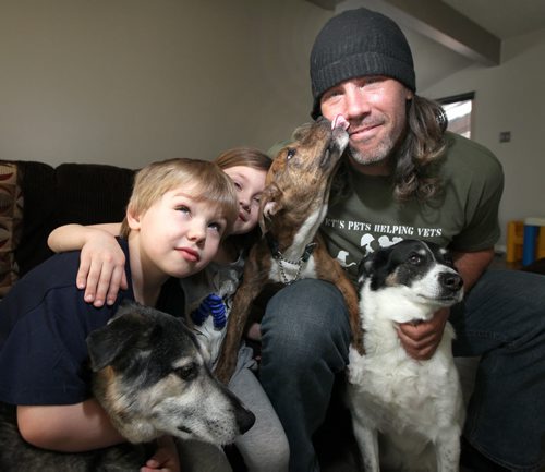 Bomber long snapper Chris Cvetkovic poses with his kids Payton and Hudson (left) along with three of his pooches  left to right Cody, Lobo who was recues in Mexico) and Jersey. See Doug Spiers story.....April 5, 2013 - (Phil Hossack / Winnipeg Free Press)