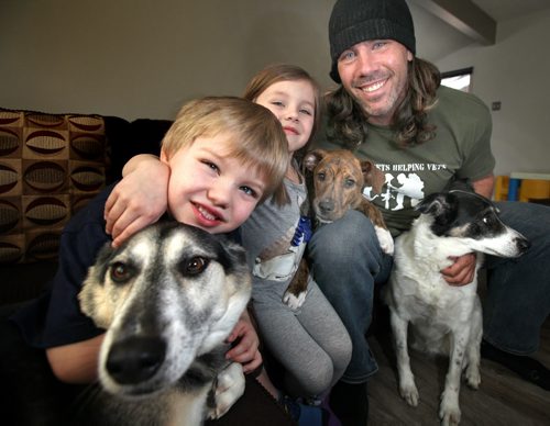Bomber long snapper Chris Cvetkovic poses with his kids Payton and Hudson (left) along with three of his pooches  left to right Cody, Lobo who was recues in Mexico) and Jersey. See Doug Spiers story.....April 5, 2013 - (Phil Hossack / Winnipeg Free Press)