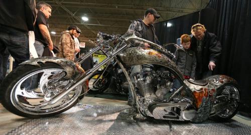 Visitors check out Gilbert Plains, Man., resident Harry Adamowski's custom-made pro street chopper 'Vengeance' at the 39th annual World of Wheels show at the Winnipeg Convention Centre on Sat., April 6, 2013. The show continues Sunday. Photo by Jason Halstead/Winnipeg Free Press