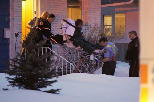 April 7, 2013 - 130407  -  Paramedics remove a person from a home on Weaver Bay where a woman was allegedly stabbed in Winnipeg Sunday, April 7, 2013. John Woods / Winnipeg Free Press