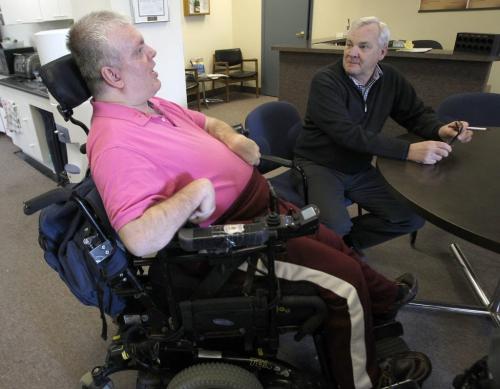 Laurie Beachell- National Coordinator from Council of Canadian with disablities, right, visits with Ron Wall in his Portage Ave office MondaySee Lindor Reynolds story- April 08, 2013   (JOE BRYKSA / WINNIPEG FREE PRESS)