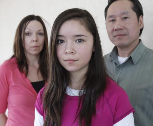In Centre,  Sage Hryciw-Pang with her parents Pam and Lionel.  The family is saying Sage has been bullied out of soccer by coaches and officials. They have asked for a transfer from North West area and have been denied and not given a reason. Ashley Prest   story.  (WAYNE GLOWACKI/WINNIPEG FREE PRESS) Winnipeg Free Press April 10 2013