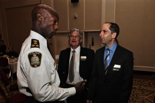 Winnipeg's Chief of Police Devon Clunis (left) chats with Darren Klassen (right) chair of BOMA (Building Owners and Managers of Manitoba) and Tom Skraba (centre) before his noon-hour speech at the Delta Hotel where he will be announcing new downtown safety initiatives. This is his first time speaking to members of BOMA the commercial real estate industry in Manitoba. 130410 April 10, 2013 Mike Deal / Winnipeg Free Press