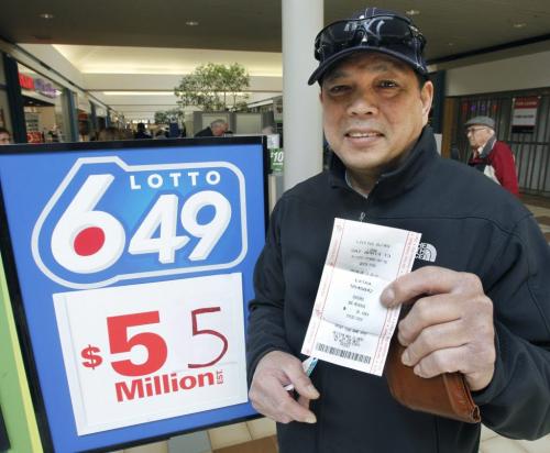 Carlito Cayanan by the kiosk in the Garden City Shopping Centre with his 649 ticket, he  is interviewed about the up coming $55 million Loto 649 draw this weekend. Intern Cindy Chan story .  (WAYNE GLOWACKI/WINNIPEG FREE PRESS) Winnipeg Free Press April 11 2013