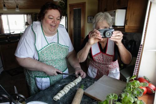 Betty Reimer (right) takes a photo for the blog while Charlotte Penner prepairs to put some puff pastry spirals into the oven. The duo created the popular cookbook, Mennonite Girls Can Cook and have just finished a new cookbook, Mennonite Girls Can Cook Celebrations. 130411 April 11, 2013 Mike Deal / Winnipeg Free Press