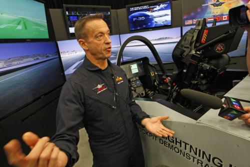 Billie Flynn  ,Senior F-35 Test Pilot , Lockheed Martin Aeronautics  and former CF-18 pilot, explains the fighter from a pilots perspective  - Magellan Aerospace Wpg is hosting media viewing of the Lockheed Martin's F-35A Lightning  interactive  cockpit demonstrator that  shows off the capabilities of the advanced multi-role fighter .The fighter program will bring $450 million  in contracts to the Wpg plant - KEN GIGLIOTTI / April . 12 2013 / WINNIPEG FREE PRESS