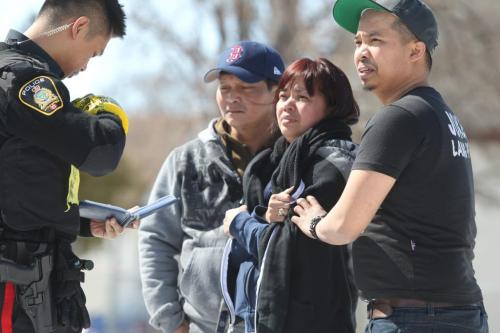 Janet Tores (middle) homeowner of 318 Union Ave. is comforted by family members as she looks on at her house which caught fire Saturday afternoon.  All her family members got safely out of the home but her family dog may have died in the blaze. See Geoff Kirbyson's story. Photography Ruth Bonneville Ruth Bonneville /  Winnipeg Free Press)